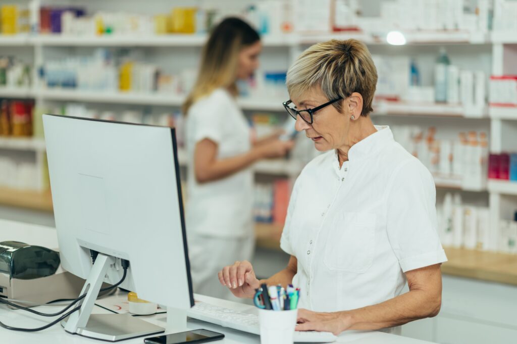 pharmaceutical sales - female pharmacist looking at screen