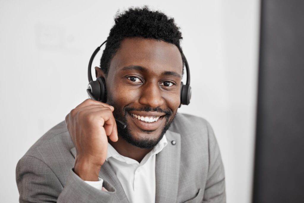 man working in a call centre at the beginning of his sales career